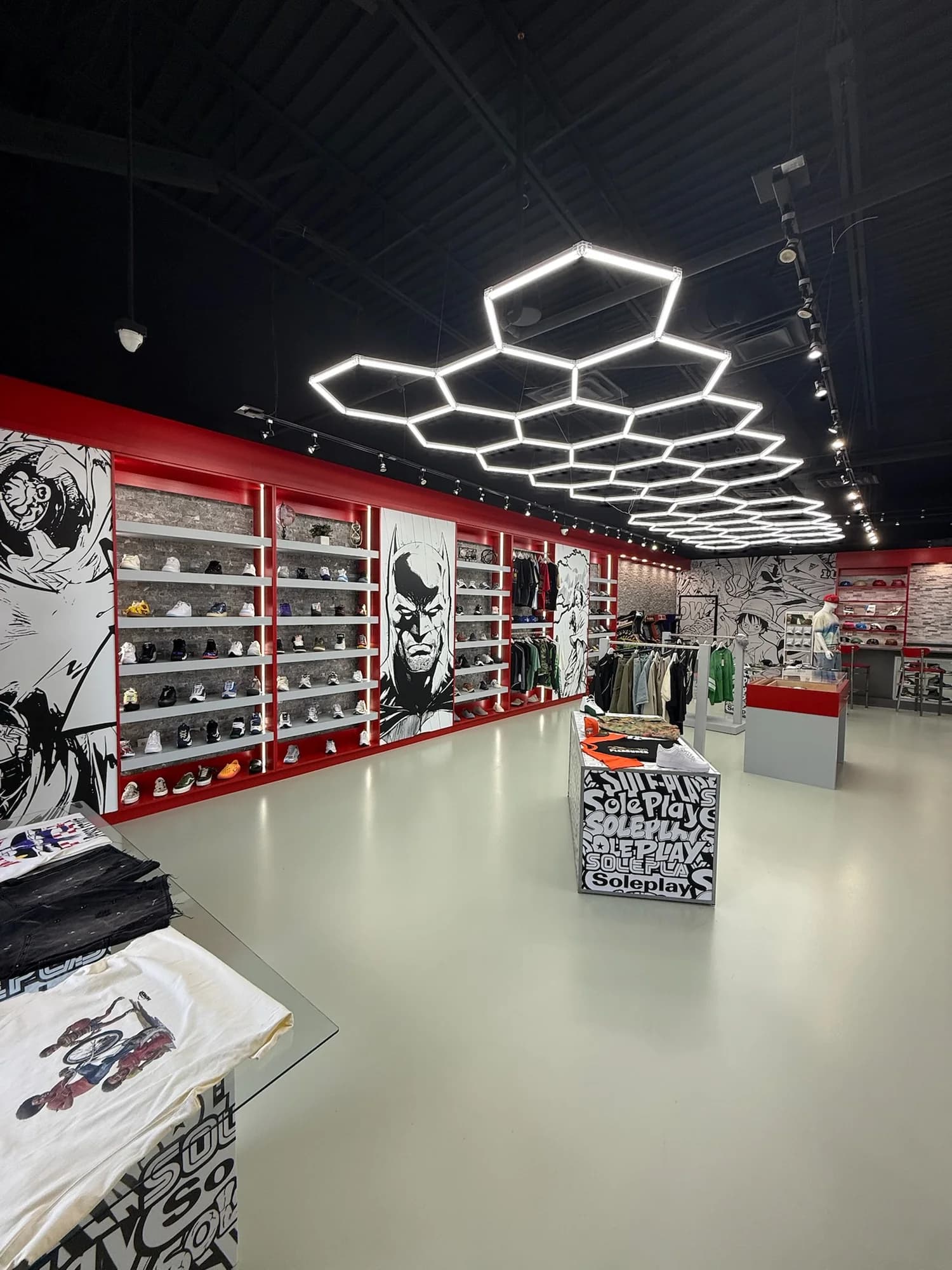 Sole Play’s red store interior with One Piece manga walls, sneaker displays, and hexagonal ceiling lights