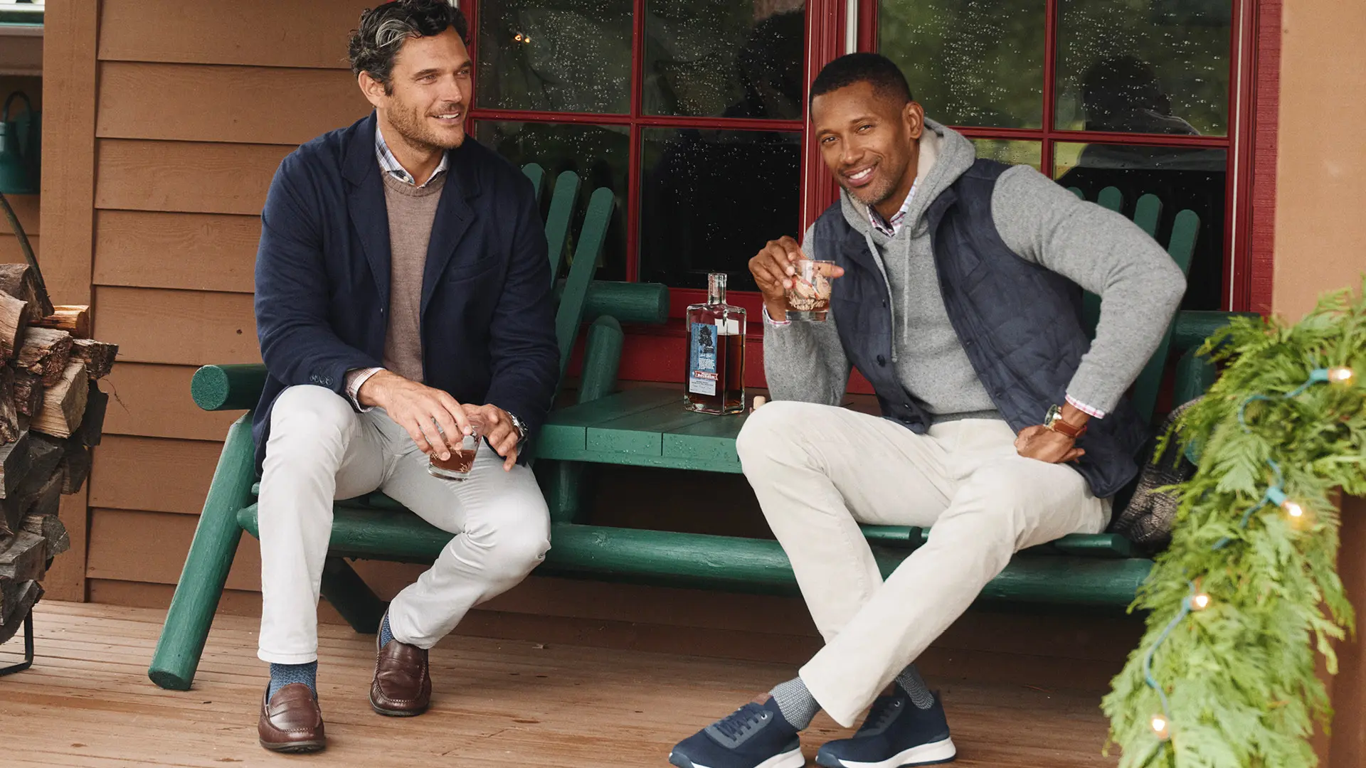 johnnie-O lifestyle photography: two men in layered apparel seated on a porch