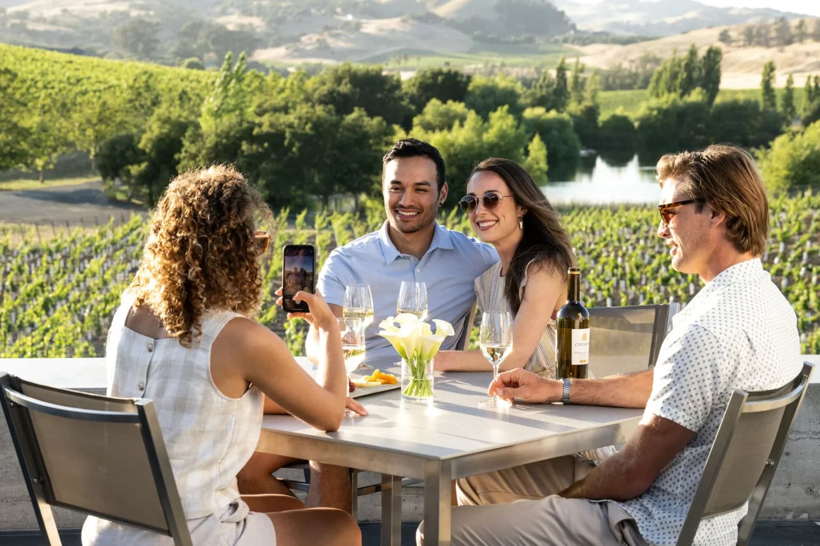 Guests enjoying wine on the Cuvaison patio overlooking vineyards